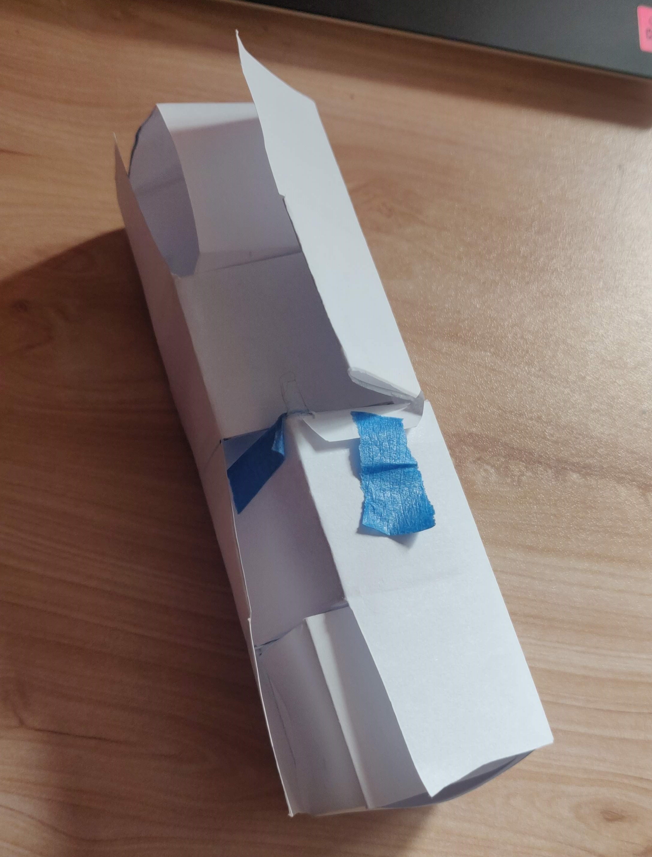 A lo-fi prototype of the glue-less roll-up map design featuring four cubes with story-related surprises inside